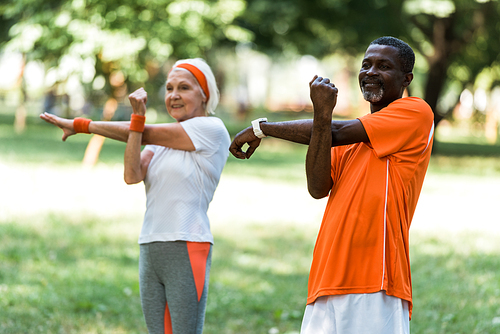 selective focus of happy senior african american man working out with retired woman