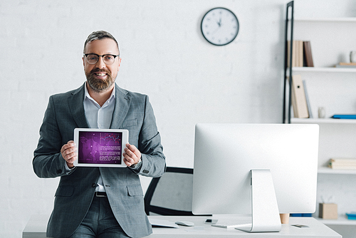 handsome businessman in formal wear holding digital tablet with health website