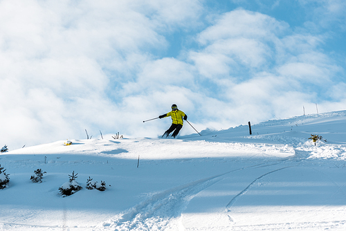 white snow near sportsman skiing against blue sky
