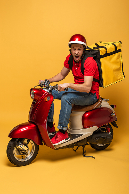 delivery man with backpack on scooter screaming on yellow background