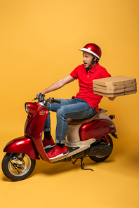 shocked delivery man in red uniform holding pizza boxes on scooter on yellow background