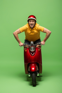 happy delivery man in yellow uniform and helmet on scooter on green