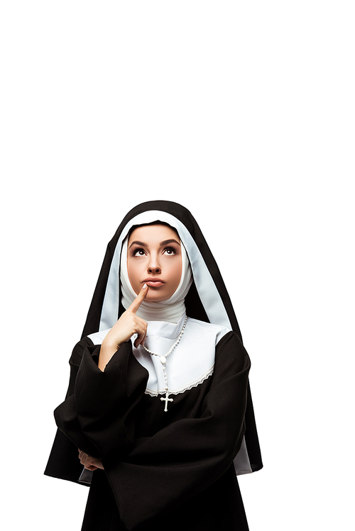 thoughtful nun in black clothing looking up, isolated on white