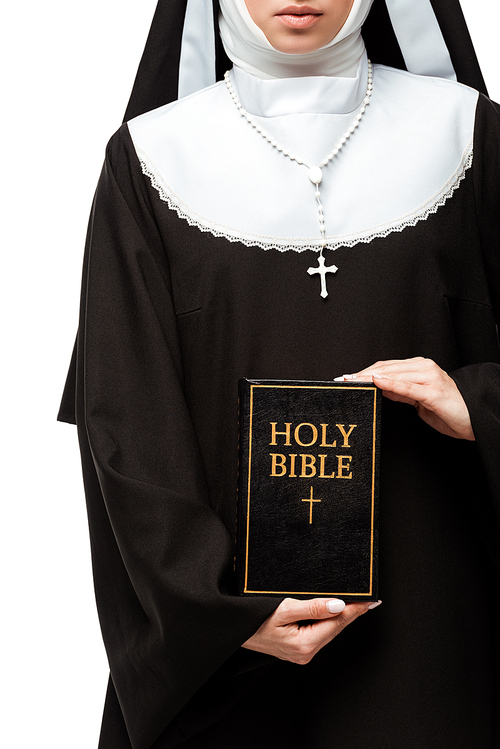 cropped view of nun holding holy bible isolated on white