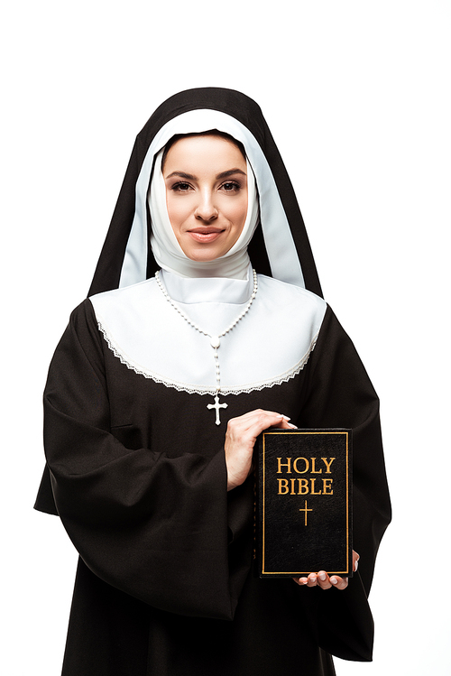 smiling nun holding holy bible isolated on white