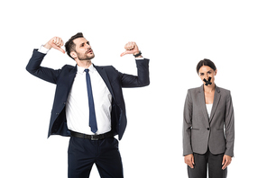 arrogant businessman pointing with thumbs at himself near businesswoman with scotch tape on mouth isolated on white