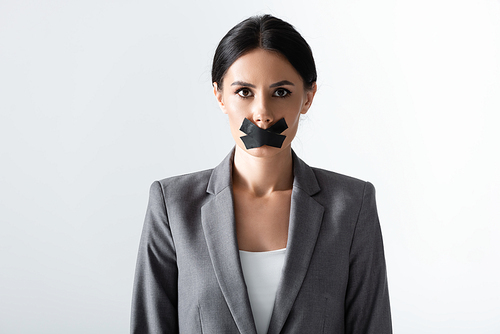 businesswoman with scotch tape on mouth standing isolated on white