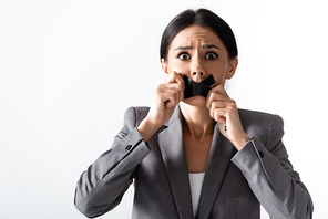 frightened businesswoman touching scotch tape on mouth isolated on white, gender inequality concept