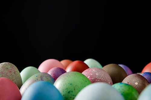 Selective focus of colorful Easter eggs isolated on black