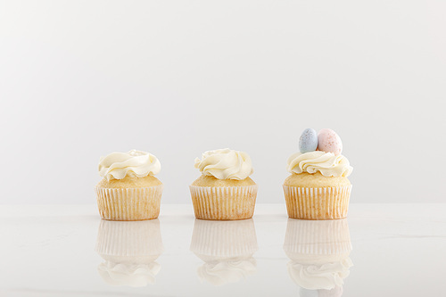 Delicious cupcakes isolated on grey