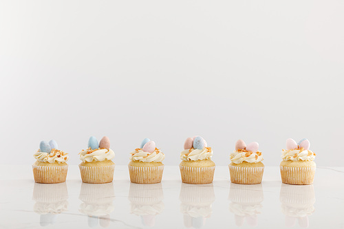 Delicious easter cupcakes isolated on grey