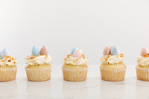 Tasty easter cupcakes isolated on grey