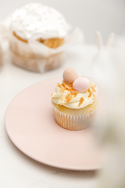 selective focus of cupcake on plate and . cake on white background