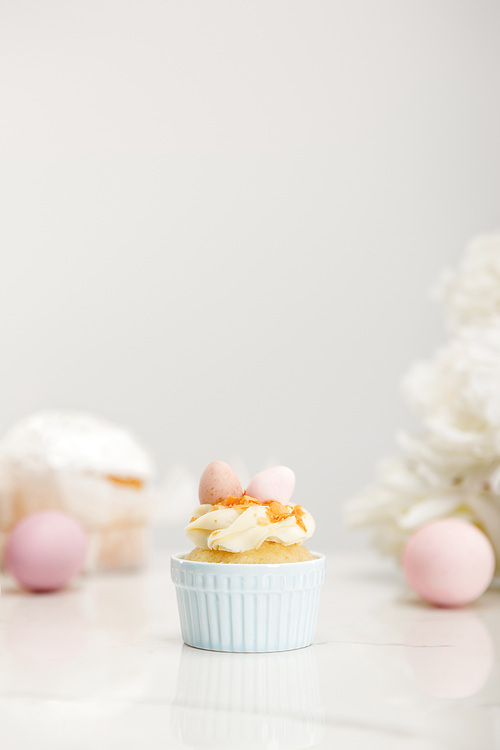 selective focus of cupcake with . eggs on grey background