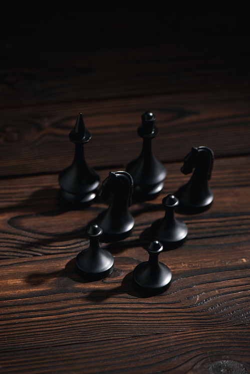 black chess figures on textured surface