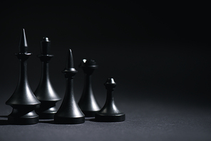 dark chess figures on black with copy space