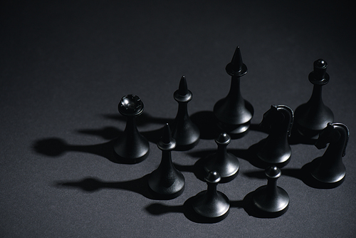 selective focus of chess figures on black with copy space