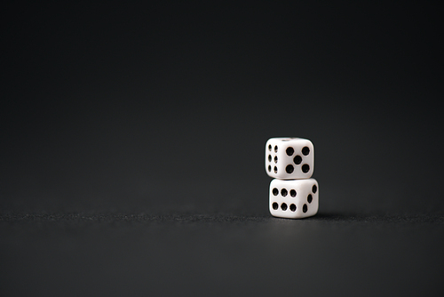 white dice on black with copy space