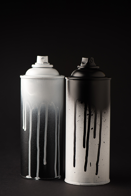 graffiti paint cans on black with copy space