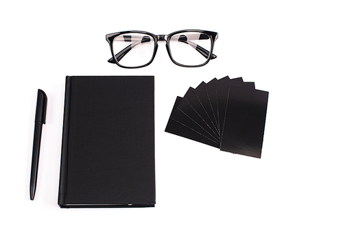 top view of notebook, pen, blank cards and glasses isolated on white