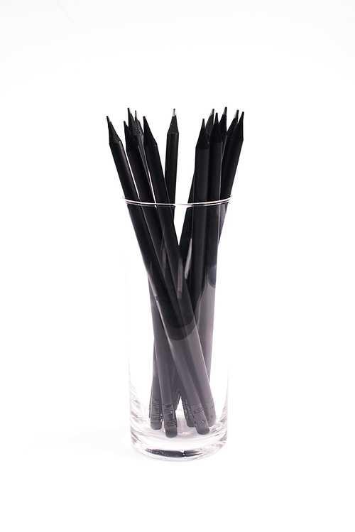 black and wooden pencils in glass isolated on white