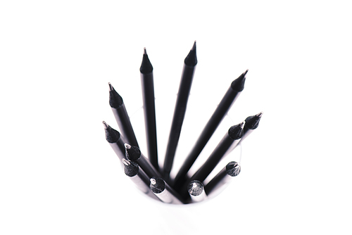 top view of black and wooden pencils isolated on white