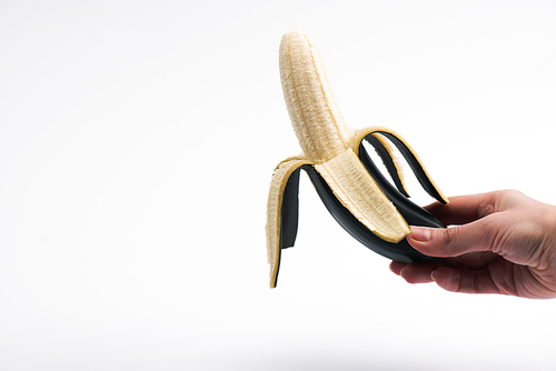 cropped view of woman holding ripe banana on white