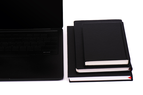 modern laptop with blank screen near black notebooks isolated on white