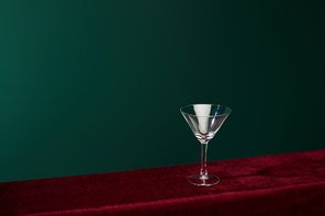 high angle view of empty cocktail glass isolated on green