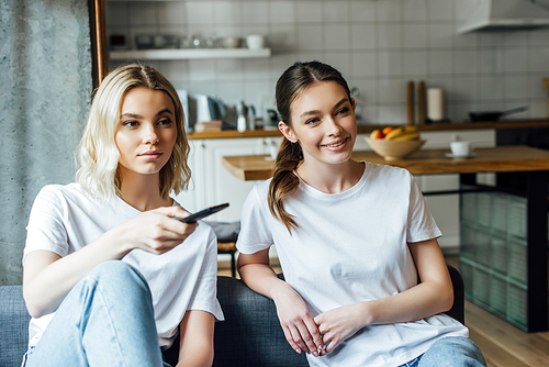 attractive and young sisters watching movie at home