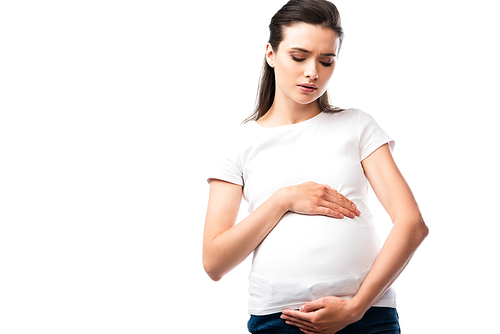 young pregnant woman in white t-shirt touching belly isolated on white