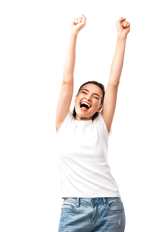 excited young woman in white t-shirt standing with hands above head isolated on white