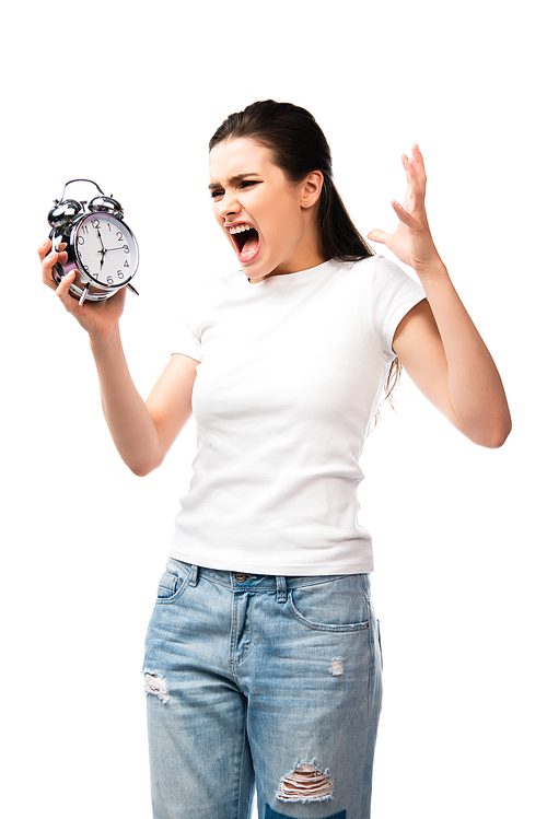 angry woman in white t-shirt holding retro alarm clock while screaming and gesturing isolated on white