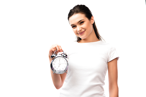 young woman in white t-shirt holding vintage alarm clock isolated on white