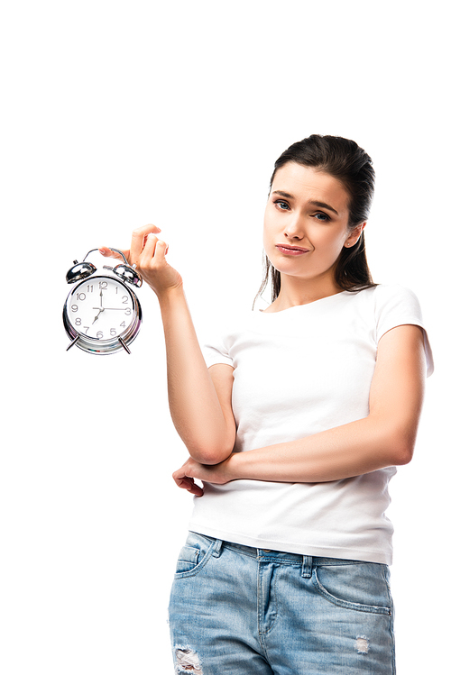 young dissatisfied woman in white t-shirt holding retro alarm clock isolated on white