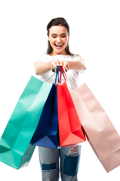 selective focus of woman holding shopping bags isolated on white