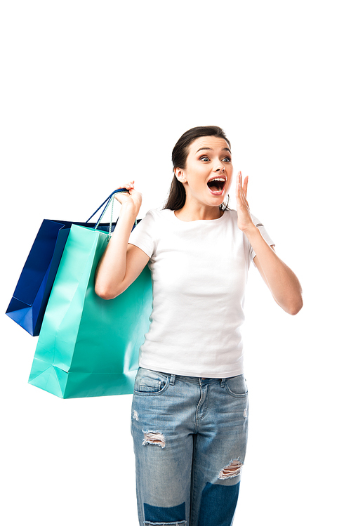 surprised woman holding shopping bags isolated on white