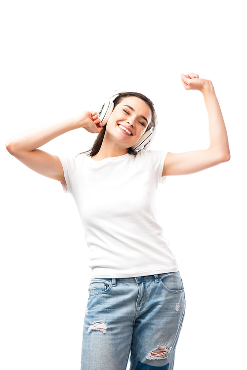 young woman with closed eyes in white t-shirt and wireless headphones isolated on white