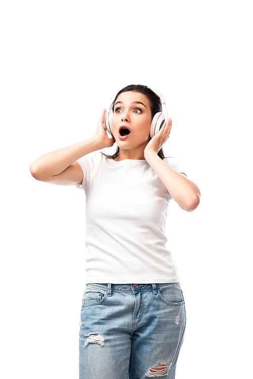 shocked young woman in white t-shirt and wireless headphones isolated on white