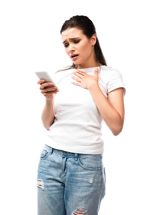 worried young woman looking at smartphone isolated on white