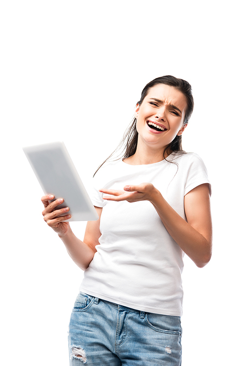 skeptical woman in white t-shirt pointing with hand at digital tablet isolated on white