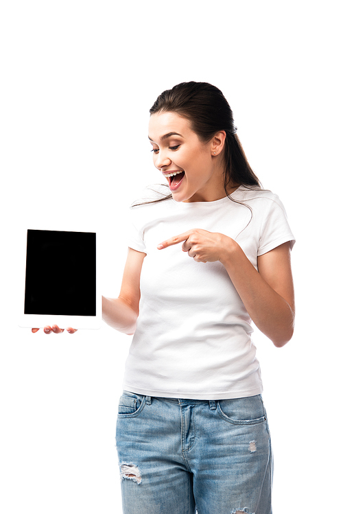 brunette woman in white t-shirt pointing with finger at digital tablet with blank screen isolated on white