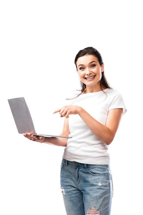 brunette woman in white t-shirt pointing with finger at laptop laptop isolated on white