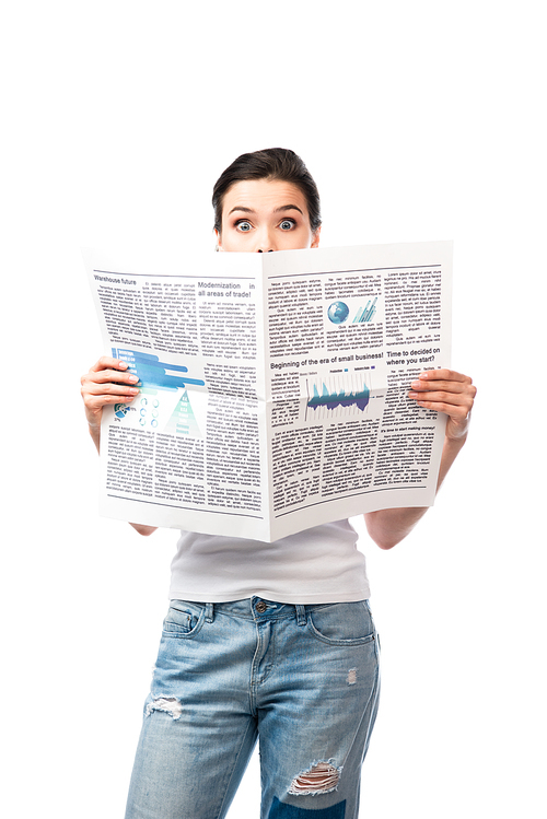 shocked brunette woman in white t-shirt covering face with newspaper isolated on white