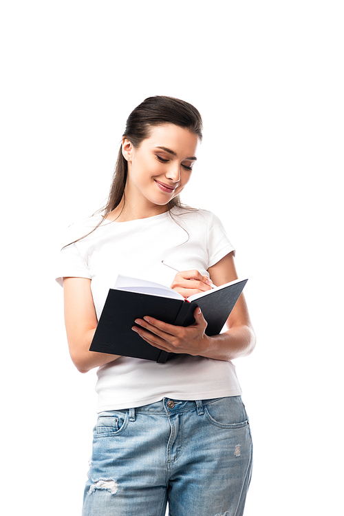 brunette woman in white t-shirt writing in notebook isolated on white