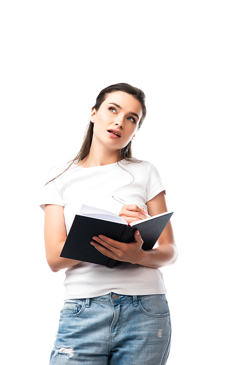 thoughtful woman in white t-shirt holding notebook and pen isolated on white