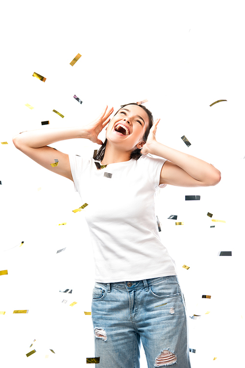 excited woman in white t-shirt gesturing near confetti on white