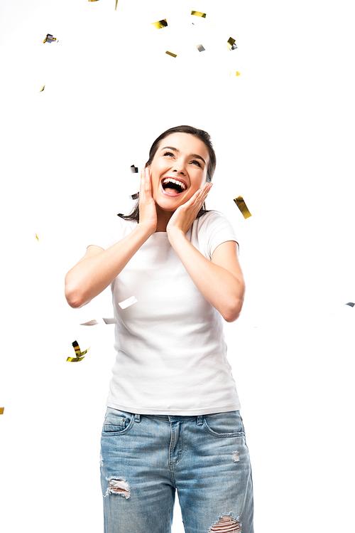 excited woman in white t-shirt standing near confetti on white