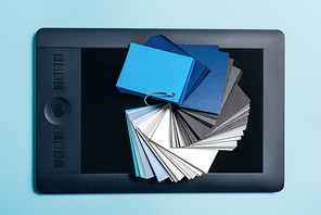 Top view of color swatches on graphics tablet on blue surface