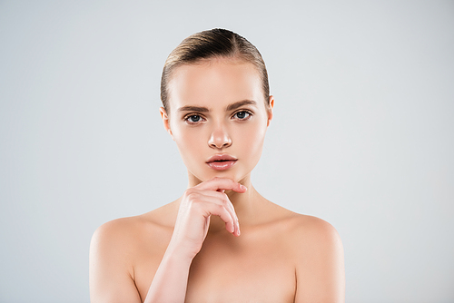 naked woman  and touching face isolated on grey